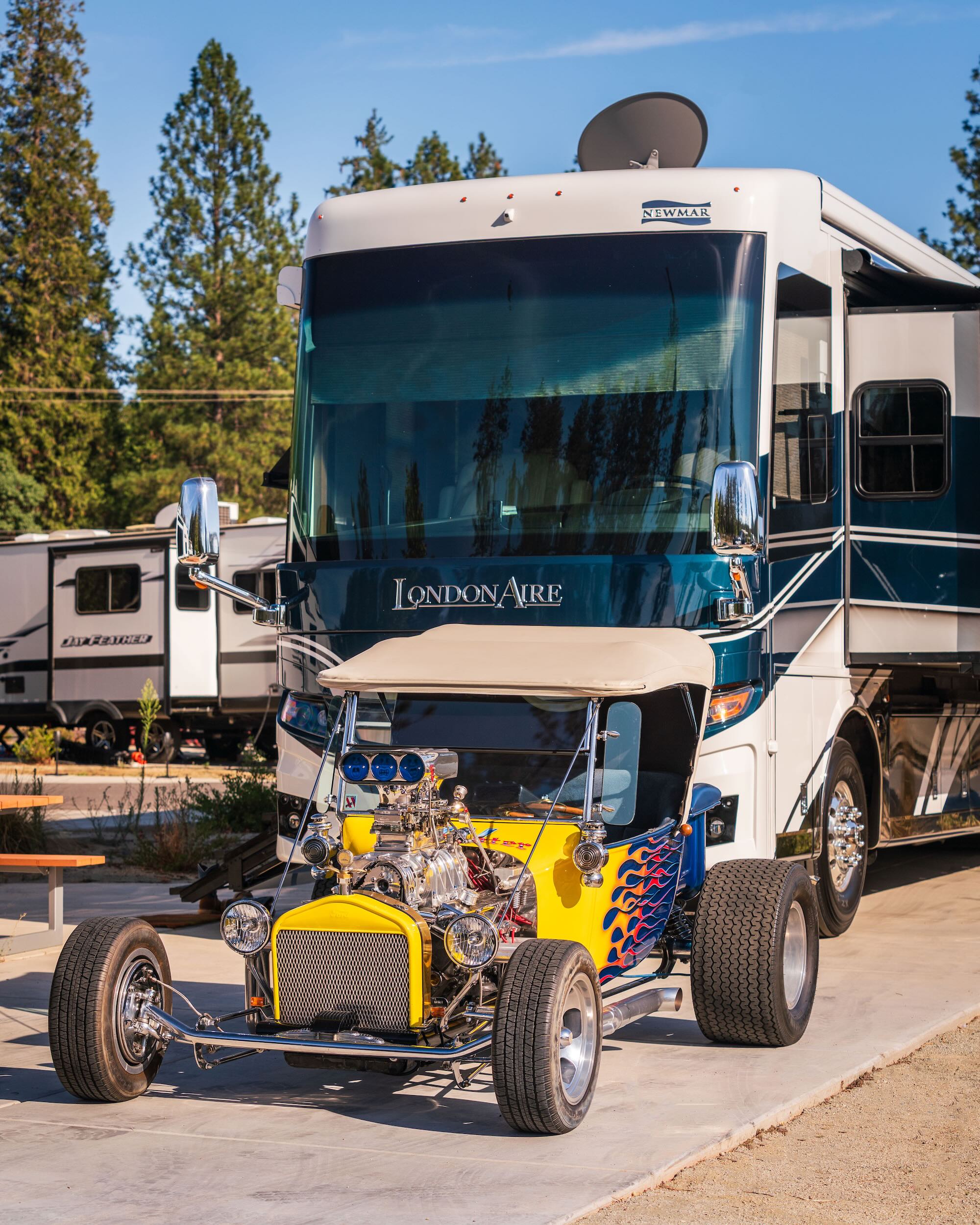 Large motorhome and vintage hot rod at Grass Valley RV Resort